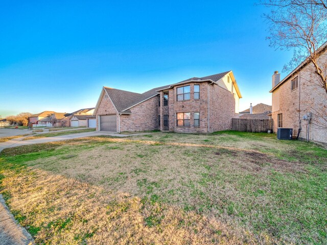 view of front of property with central AC and a front lawn