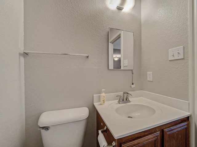 bathroom featuring toilet and vanity