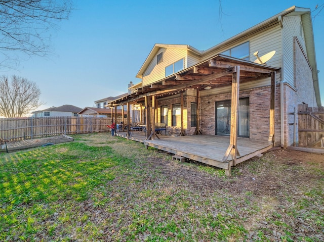 back of house featuring a yard and a wooden deck