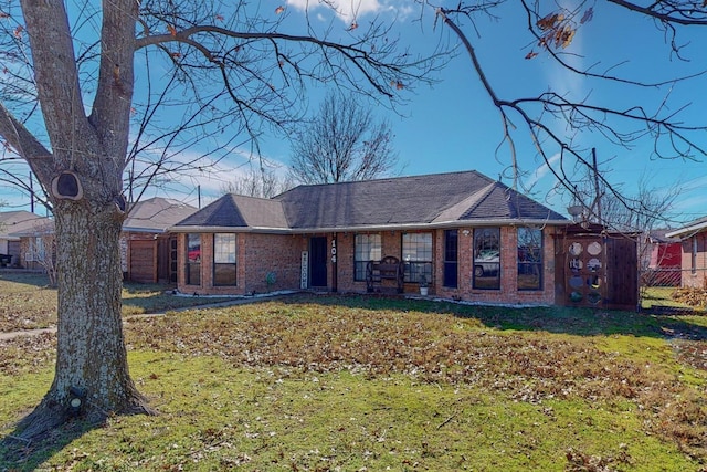 ranch-style home featuring a front yard