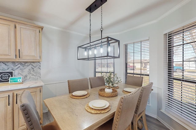 dining area with wood-type flooring and ornamental molding