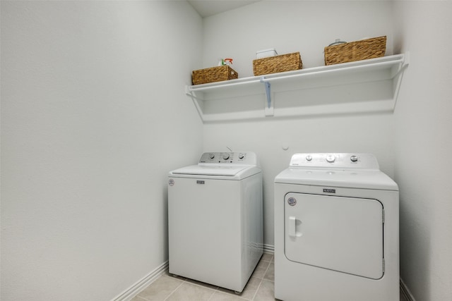 clothes washing area featuring light tile patterned flooring and independent washer and dryer