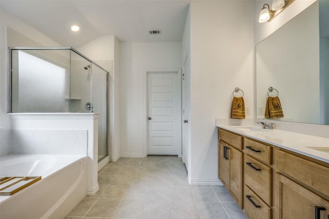 bathroom with tile patterned flooring, vanity, and separate shower and tub