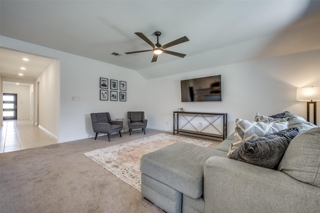 living room featuring light colored carpet, vaulted ceiling, and ceiling fan