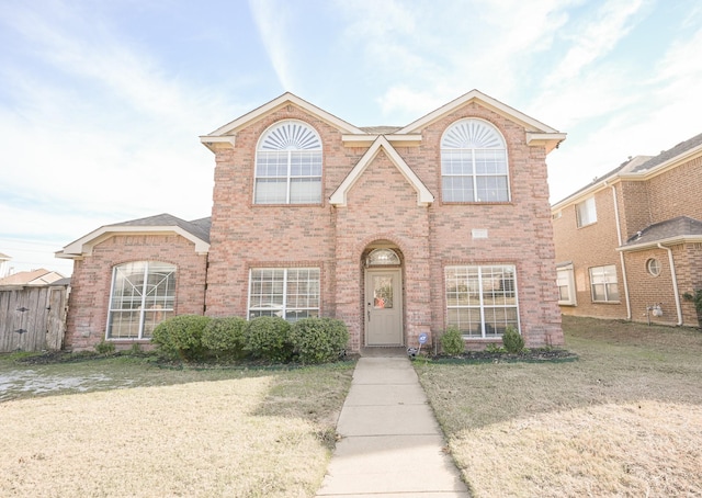 traditional-style house featuring brick siding