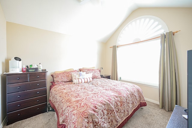 bedroom featuring light carpet and lofted ceiling