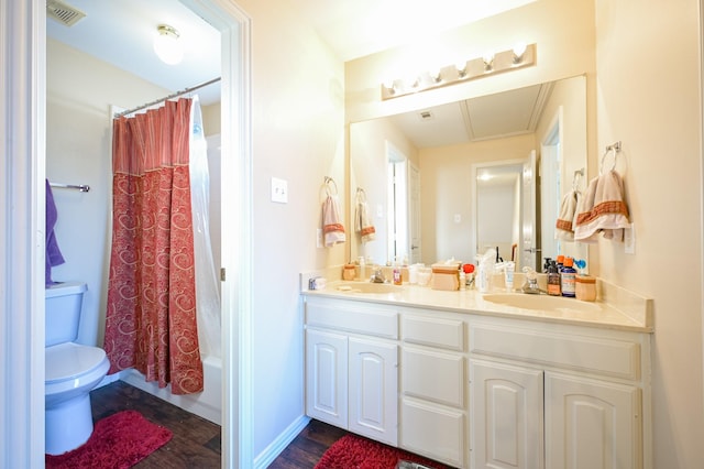 full bathroom with hardwood / wood-style floors, vanity, toilet, and shower / bathtub combination with curtain