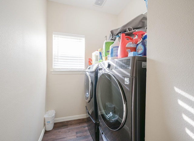 washroom featuring separate washer and dryer and dark hardwood / wood-style floors