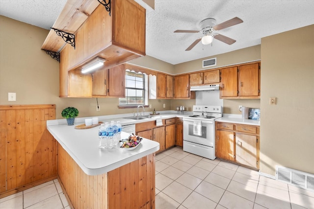 kitchen with sink, white appliances, a textured ceiling, and kitchen peninsula