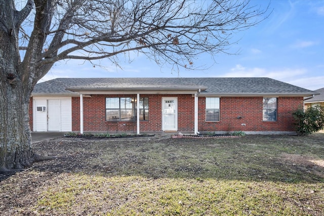 single story home with a front yard and a garage