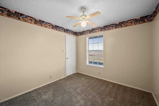 carpeted spare room featuring a textured ceiling and ceiling fan