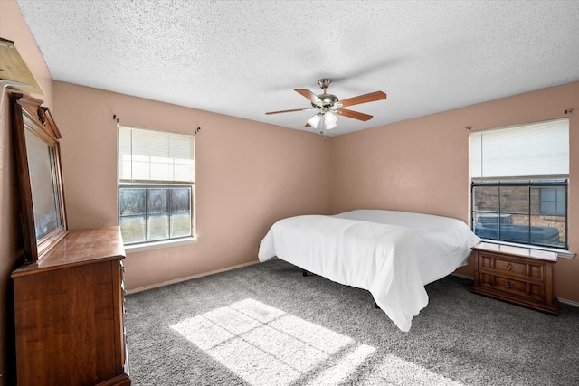 carpeted bedroom with a textured ceiling and ceiling fan