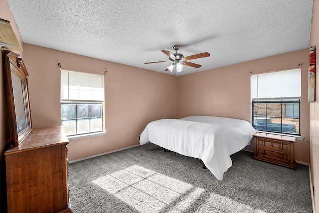 unfurnished bedroom featuring carpet floors, ceiling fan, and a textured ceiling