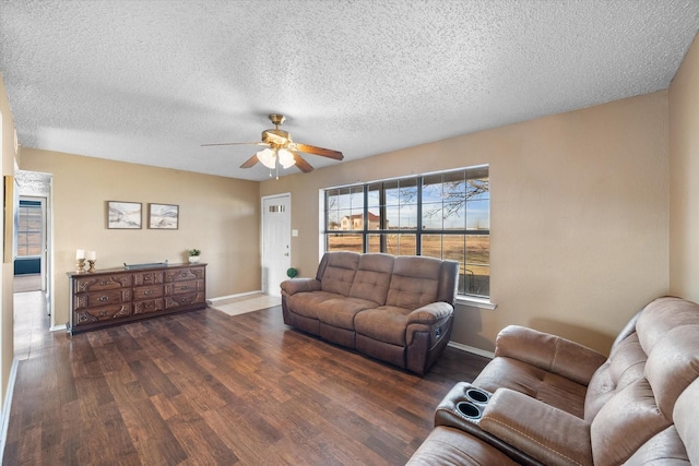 living room featuring a textured ceiling, ceiling fan, and dark hardwood / wood-style flooring