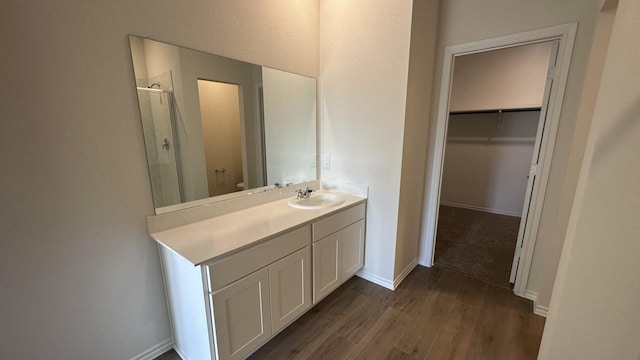 bathroom featuring vanity, hardwood / wood-style floors, a shower with shower door, and toilet