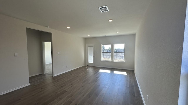 empty room with dark wood-type flooring