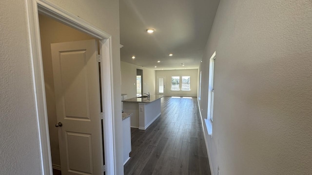 corridor featuring sink and dark hardwood / wood-style flooring