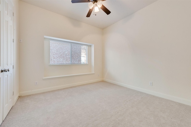 spare room with light carpet and ceiling fan