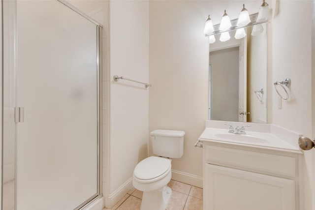 bathroom with toilet, vanity, tile patterned floors, and an enclosed shower