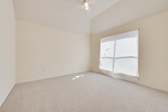 spare room featuring ceiling fan, lofted ceiling, light carpet, and a wealth of natural light