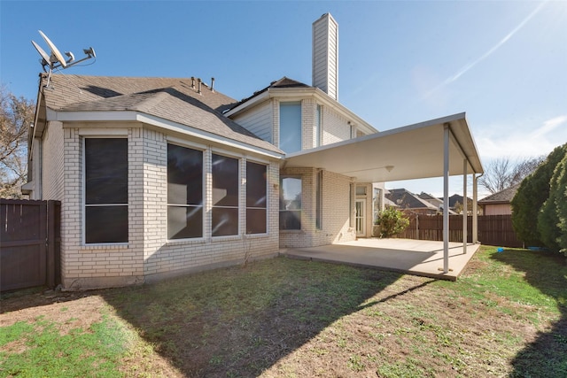 rear view of house with a patio area and a yard