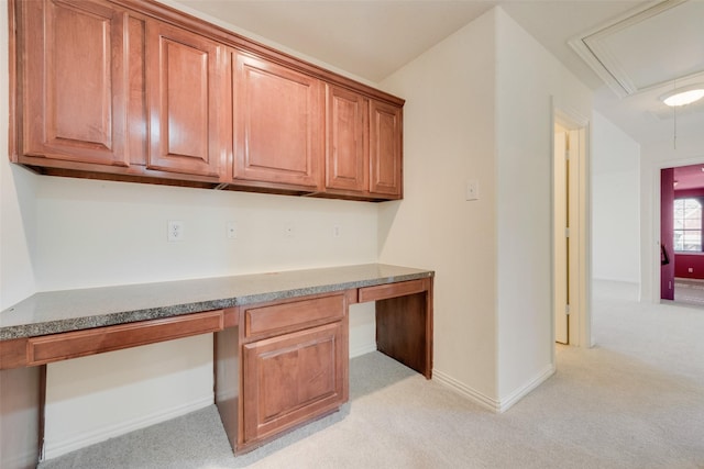 unfurnished office with light colored carpet and built in desk