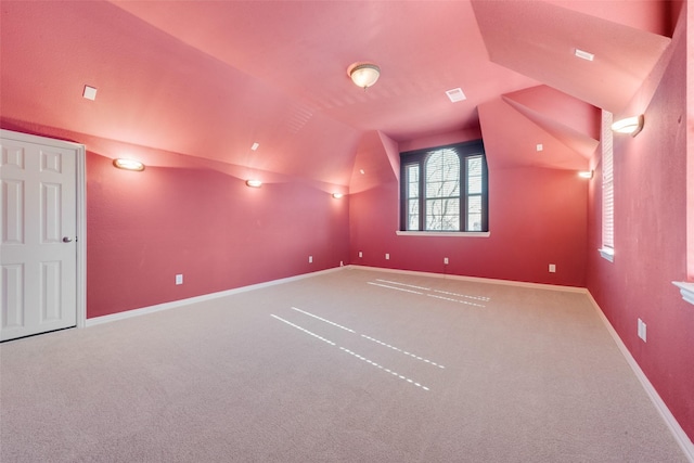 carpeted home theater room featuring lofted ceiling