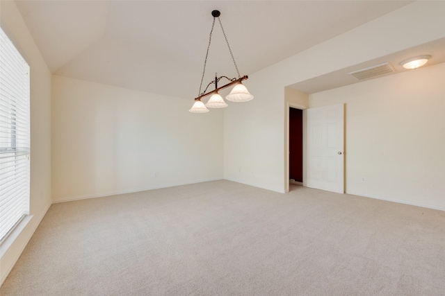 unfurnished room with lofted ceiling and carpet floors