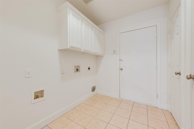 washroom with electric dryer hookup, hookup for a washing machine, light tile patterned floors, and cabinets