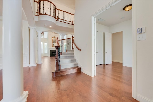 foyer with hardwood / wood-style flooring and ornate columns