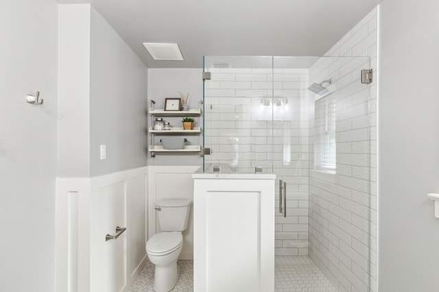 bathroom featuring toilet and an enclosed shower