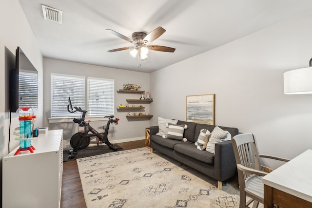 living room with ceiling fan and dark hardwood / wood-style floors