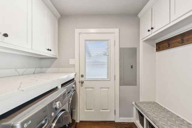 laundry area featuring electric panel, dark wood-type flooring, cabinets, and separate washer and dryer