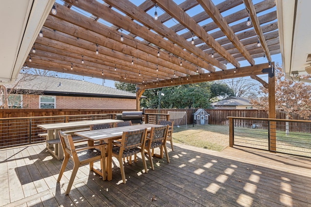 deck with a pergola and a grill