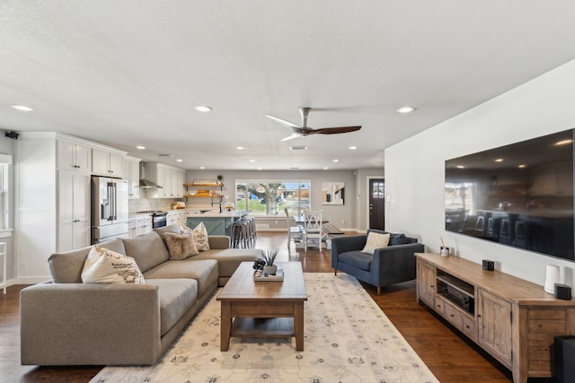 living room with ceiling fan and light hardwood / wood-style flooring