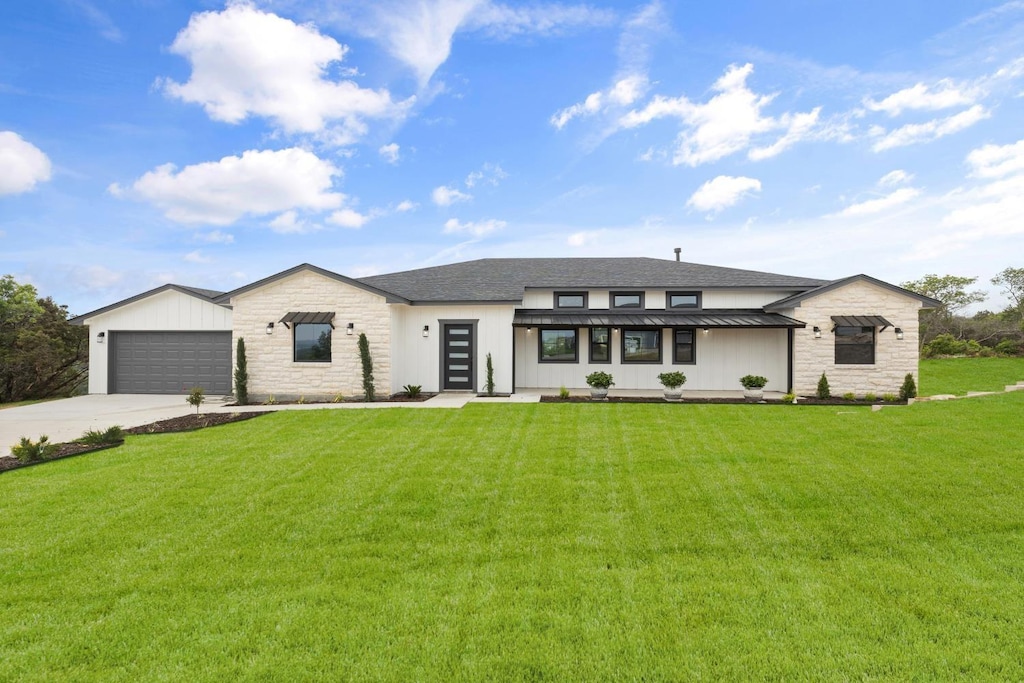 view of front of house with a garage and a front lawn