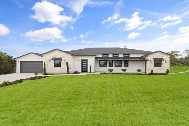 view of front of house with a garage and a front lawn