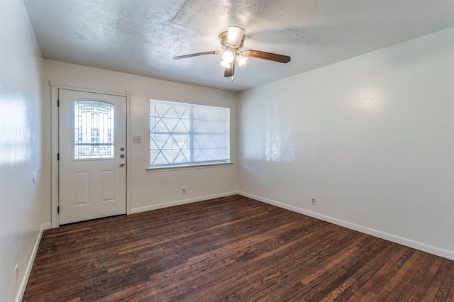 entryway with dark hardwood / wood-style floors, ceiling fan, and a textured ceiling