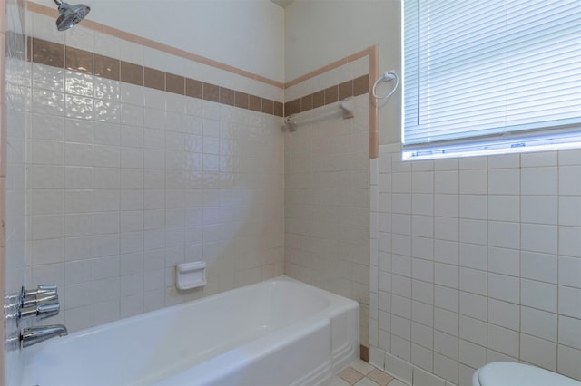 bathroom featuring tile patterned floors, bathing tub / shower combination, and toilet