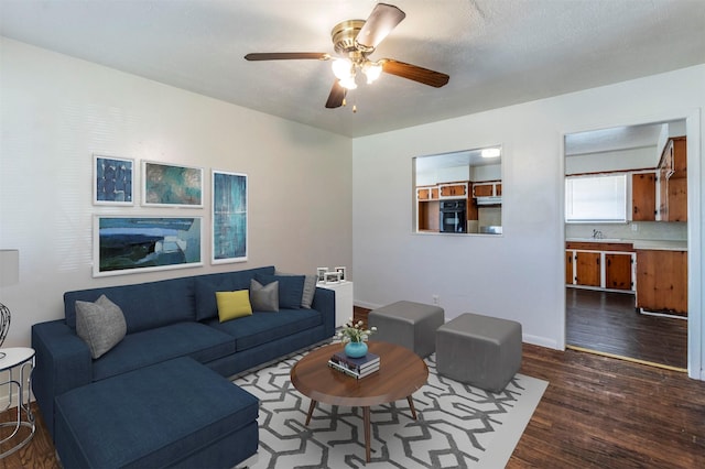 living room with ceiling fan, dark hardwood / wood-style flooring, and sink