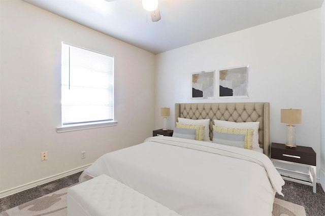 bedroom with ceiling fan and dark carpet