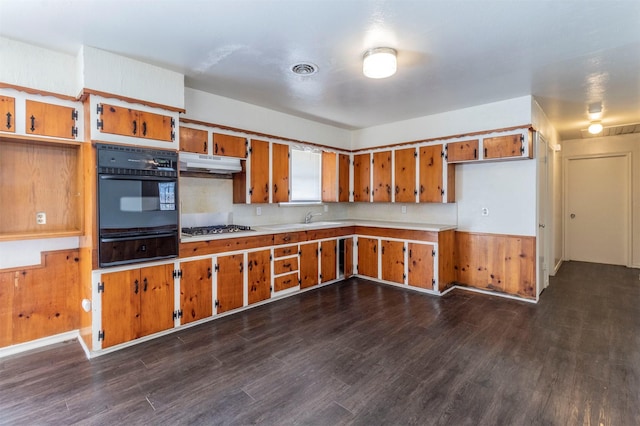 kitchen featuring tasteful backsplash, stainless steel gas cooktop, dark wood-type flooring, and sink