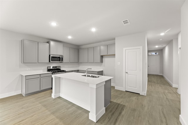 6721 Golden Grove Rd, Fort Worth, TX 76123 - kitchen featuring appliances with stainless steel finishes, gray cabinets, a sink, an island with sink, and recessed lighting