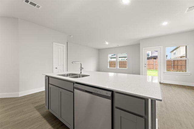 6721 Golden Grove Rd, Fort Worth, TX 76123 - kitchen with stainless steel dishwasher, a sink, gray cabinetry, baseboards, and light wood-style flooring