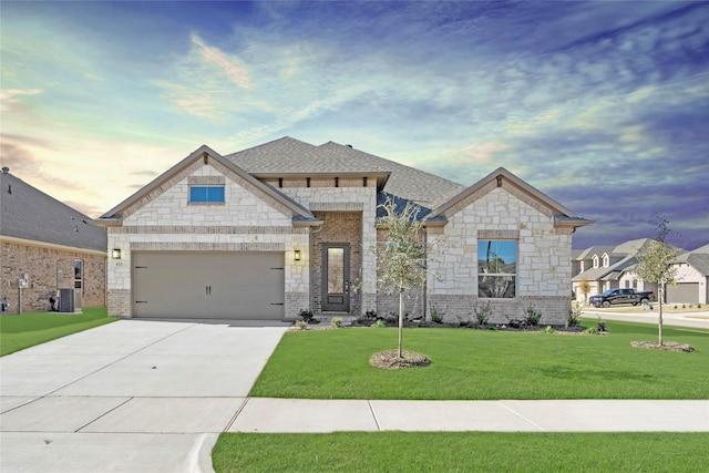 view of front facade with driveway, a shingled roof, a front yard, and brick siding