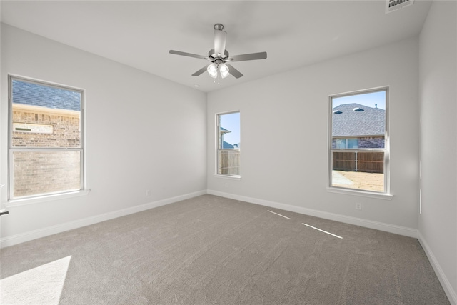 empty room with ceiling fan and carpet