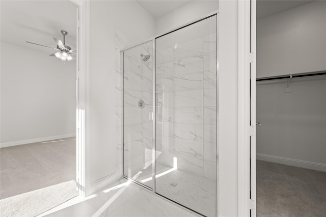 bathroom featuring an enclosed shower and ceiling fan