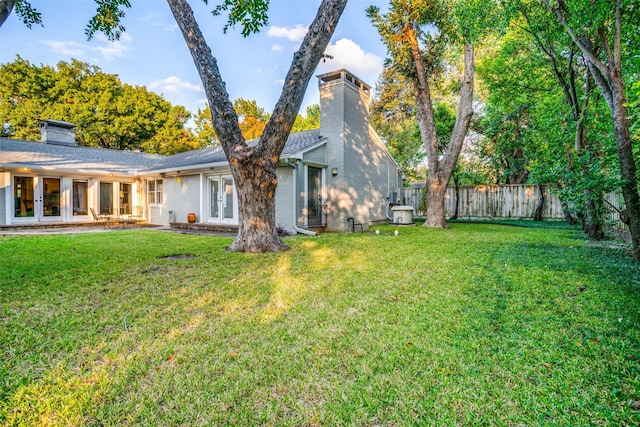 rear view of property with a yard and french doors