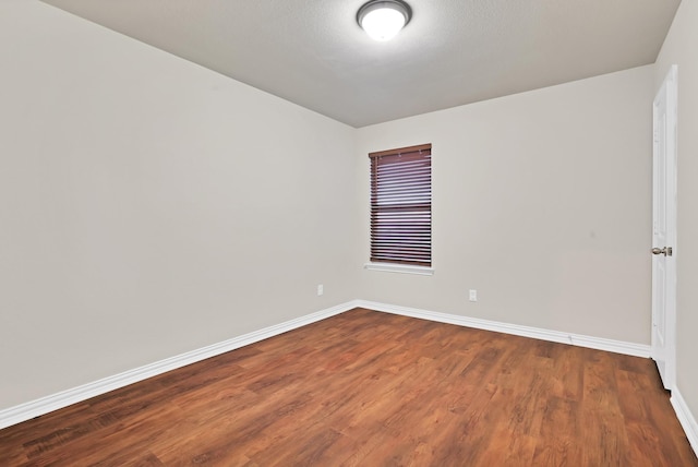 empty room with hardwood / wood-style flooring