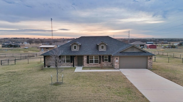 view of front of property featuring a garage and a lawn